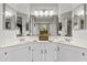 Bright bathroom with dual sinks, white cabinets, and large mirrors creates a spacious and clean atmosphere at 1135 W Sea Fog Dr, Gilbert, AZ 85233