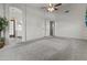 Spacious bedroom with high ceilings, carpet floors, and an open doorway to the bathroom at 1135 W Sea Fog Dr, Gilbert, AZ 85233