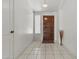 Welcoming foyer features tile flooring and a stylish wooden front door at 1135 W Sea Fog Dr, Gilbert, AZ 85233