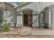 Charming front entrance with a textured stucco facade, arched entryway, and well-maintained landscaping at 1135 W Sea Fog Dr, Gilbert, AZ 85233
