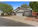 Charming single-story home with a three-car garage, well-manicured lawn, and mature trees for curb appeal at 1135 W Sea Fog Dr, Gilbert, AZ 85233