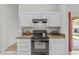 Efficient kitchen with sleek black appliances and bright white cabinets at 1135 W Sea Fog Dr, Gilbert, AZ 85233
