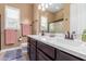 Spacious bathroom featuring double sinks, white marble counters, and bronze fixtures at 13720 N 148Th Dr, Surprise, AZ 85379