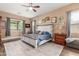 Bedroom with wood-look flooring, ceiling fan, and serene decor for a restful retreat at 13720 N 148Th Dr, Surprise, AZ 85379