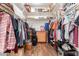 Walk-in closet provides ample storage with built-in shelving and wooden floor at 13720 N 148Th Dr, Surprise, AZ 85379