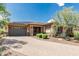 Charming single-story home with stone accents, a paved driveway, desert landscaping, and a two-car garage at 13720 N 148Th Dr, Surprise, AZ 85379