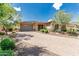 Charming single-story home with stone accents, a paved driveway, desert landscaping, and a two-car garage at 13720 N 148Th Dr, Surprise, AZ 85379