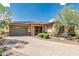 Charming single-story home with stone accents, a paved driveway, desert landscaping, and a two-car garage at 13720 N 148Th Dr, Surprise, AZ 85379