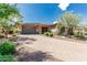 Charming single-story home with stone accents, a paved driveway, desert landscaping, and a two-car garage at 13720 N 148Th Dr, Surprise, AZ 85379