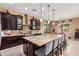 Gourmet kitchen featuring custom cabinetry, granite countertops, and a center island, ideal for cooking and gathering at 13720 N 148Th Dr, Surprise, AZ 85379