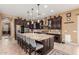Spacious kitchen features a large island with bar seating, stainless steel appliances, and plenty of cabinet space at 13720 N 148Th Dr, Surprise, AZ 85379