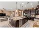 Open kitchen boasts a sizable center island, modern appliances, and connects seamlessly to the living area at 13720 N 148Th Dr, Surprise, AZ 85379
