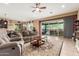 Inviting living room featuring a ceiling fan, an area rug and sliding glass doors to the patio at 13720 N 148Th Dr, Surprise, AZ 85379
