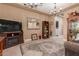Inviting living room featuring tile floors, elegant chandeliers, and an entertainment center with a fireplace at 13720 N 148Th Dr, Surprise, AZ 85379