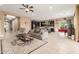 Open-concept living space with tile flooring, seamlessly connecting the living area to the dining and kitchen at 13720 N 148Th Dr, Surprise, AZ 85379