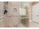 Walk-in shower featuring custom tiling, a glass enclosure, and modern fixtures, offering a luxurious bathing experience at 13720 N 148Th Dr, Surprise, AZ 85379