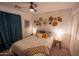Cozy bedroom featuring a ceiling fan, warm lighting and stylish decorative wall art at 16021 N 30Th St # 127, Phoenix, AZ 85032