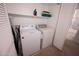 Functional laundry room with a washer and dryer, plus a storage shelf for convenience at 16021 N 30Th St # 127, Phoenix, AZ 85032