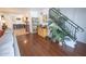 Open-concept living room with hardwood floors, decorative plants, and staircase at 16021 N 30Th St # 127, Phoenix, AZ 85032