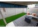 Cozy outdoor patio with white sofa, throw pillows, decorative rug, and small grass area at 16021 N 30Th St # 127, Phoenix, AZ 85032