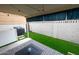Inviting covered patio space with artificial turf, string lights, and patterned outdoor rug at 16021 N 30Th St # 127, Phoenix, AZ 85032
