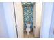 Stylish powder room featuring vibrant tropical leaf wallpaper, adding character to the space at 16021 N 30Th St # 127, Phoenix, AZ 85032