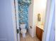 Charming powder room boasts tropical leaf wallpaper, adding a vibrant touch and a modern sink at 16021 N 30Th St # 127, Phoenix, AZ 85032