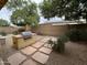 Enjoy the outdoors with a stone paver walkway, built in barbecue and mature trees in the backyard at 16528 W Lariat Ln, Surprise, AZ 85387