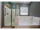Bathroom features shower, tub, and window with natural light at 16528 W Lariat Ln, Surprise, AZ 85387