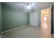 Bedroom with light green walls, wood-look tile flooring, and closet at 16528 W Lariat Ln, Surprise, AZ 85387