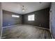 The bedroom has a ceiling fan and light hardwood floors, and neutral paint at 16528 W Lariat Ln, Surprise, AZ 85387