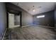 Large bedroom features wood-look tile flooring, ceiling fan, and natural light at 16528 W Lariat Ln, Surprise, AZ 85387