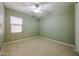 This bedroom offers a ceiling fan and a window with nice natural light at 16528 W Lariat Ln, Surprise, AZ 85387
