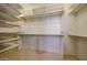 A large walk-in closet with lots of storage for clothes and shelves at 16528 W Lariat Ln, Surprise, AZ 85387