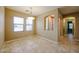 Bright dining room with tiled flooring, lots of natural light, and archway at 16528 W Lariat Ln, Surprise, AZ 85387