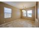 Cozy dining room with three windows providing natural light and tiled floor at 16528 W Lariat Ln, Surprise, AZ 85387