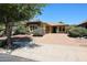 Inviting single-Gathering home with a brick driveway, stone accents, and a two-car garage at 16528 W Lariat Ln, Surprise, AZ 85387
