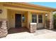 Inviting front porch with stone pillars, security door, and charming exterior details at 16528 W Lariat Ln, Surprise, AZ 85387