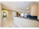 Open kitchen features granite counters, light wood cabinets, and tile flooring at 16528 W Lariat Ln, Surprise, AZ 85387