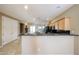 Open kitchen features granite counters, light wood cabinets, and black appliances at 16528 W Lariat Ln, Surprise, AZ 85387