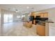 The kitchen features wooden cabinets, dark appliances, an island, and plenty of counter space at 16528 W Lariat Ln, Surprise, AZ 85387