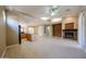 Open floor plan with tile floors, and a fireplace with a stone surround at 16528 W Lariat Ln, Surprise, AZ 85387