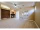 Open living room with a fireplace, ceiling fan, sliding doors and natural light at 16528 W Lariat Ln, Surprise, AZ 85387