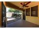 Covered patio with ceiling fan overlooking fenced backyard, perfect for outdoor entertaining at 16528 W Lariat Ln, Surprise, AZ 85387