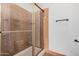 Bathroom featuring a glass enclosed shower with brown tile at 17830 N 45Th Ave, Glendale, AZ 85308