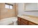 Cozy bathroom with a tile shower and a wooden vanity at 17830 N 45Th Ave, Glendale, AZ 85308