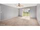 Bright bedroom with carpet, ceiling fan, and sliding door access to the backyard at 17830 N 45Th Ave, Glendale, AZ 85308