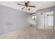 Neutral bedroom with a ceiling fan, window and sliding closet doors at 17830 N 45Th Ave, Glendale, AZ 85308