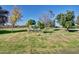 The Bellair Community sign, surrounded by lush green grass and mature trees, adds charm to the neighborhood entrance at 17830 N 45Th Ave, Glendale, AZ 85308