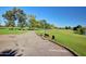 Inviting golf course with a paved path, bench seating, and a well-maintained green, perfect for relaxing play at 17830 N 45Th Ave, Glendale, AZ 85308